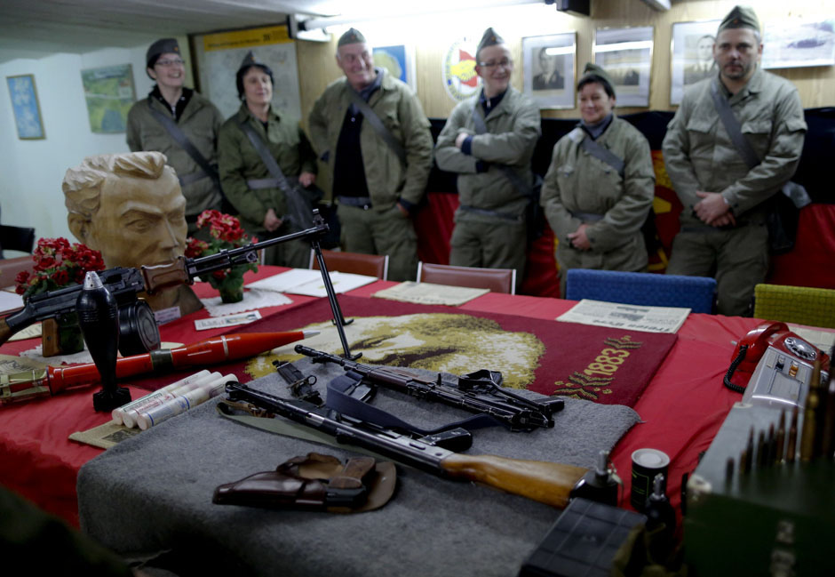 Participants dressed as NVA soldiers look at weapons during the 'reality event' one night at the 'Bunker-Museum' in Rennsteighoehe