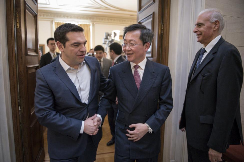 Handout photo of Greek PM Tsipras welcoming China COSCO's chairman Xu Lirong before the signing of the sale of the country's biggest port to shipping giant China COSCO Shipping Corporation at the Maximos Mansion