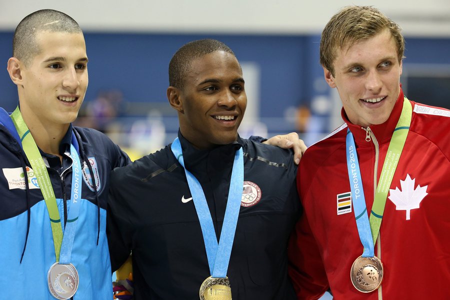 epa04849842 (L-R) Santiago Grassi from Argentina (silver), Giles Smith from the United States (gold) and Santo Condorelli from Canada (bronze) pose with their medals in Men's 100 m butterfly at the Pan American Games 2015 in Toronto, Canada, 16 July 2015. EPA/ALEJANDRO ERNESTO