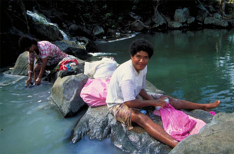 Washing clothes in stream