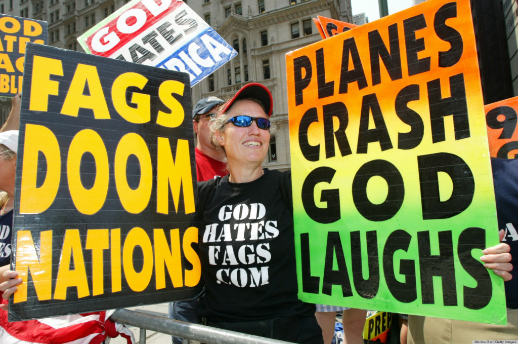 NEW YORK - JULY 4:  Shirley Phelps-Roper holds up signs as she joins fellow members of the Westboro Baptist Church, from Topeka, Kansas, as they protest across the street from Ground Zero July 4, 2004 in New York City. The church members believe that because of homosexuals and America's rebelious and immoral conducts, God has brought on acts of terrorism as a way of punishing society.  (Photo by Monika Graff/Getty Images)