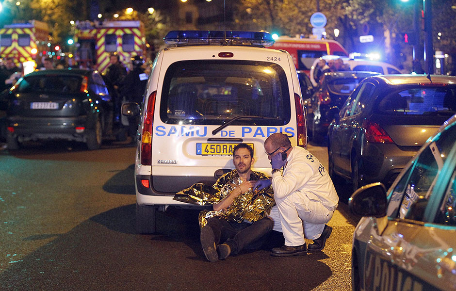 PARIS, FRANCE - NOVEMBER 13:  A medic tends to a man November 13, 2013 in Paris, France. Gunfire and explosions in multiple locations erupted in the French capital with early casualty reports indicating at least 60 dead. (Photo by Thierry Chesnot/Getty Images)