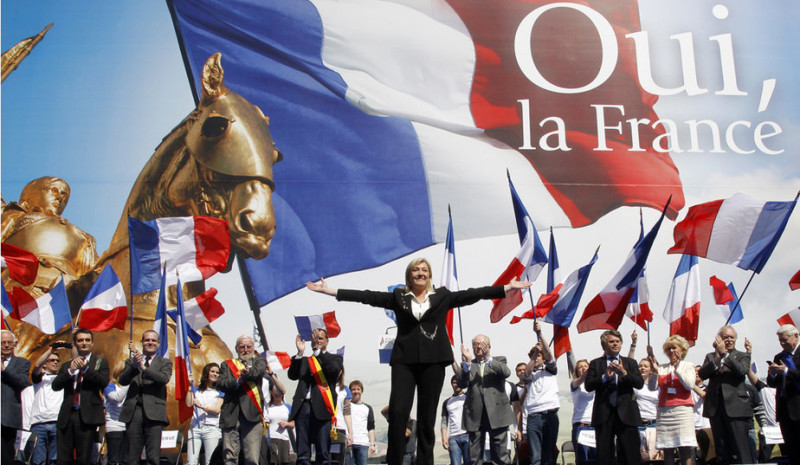 France's far right National Front political party leader Marine Le Pen waves on stage during her speech in front of the Opera following the National Front's annual May Day rally in Paris May 1, 2012. REUTERS/Benoit Tessier (FRANCE - Tags: POLITICS)