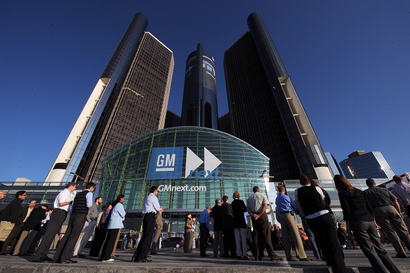 General Motors employees and visitors watch a large video monitor outside the GM World Headquarters at the Renaissance Center in Detroit, Michigan to watch the GM 100-year celebration Tuesday, September 16, 2008. GM unveiled the production model Chevrolet Volt electric vehicle at part of the ceremonies. (Photo by Steve Fecht for General Motors)