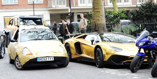 30.March.2016 - LONDON - UK A reporter wraps his Ford KA in gold foil and tries to blend in with a fleet of golden supercars owned by a Saudi Prince! The Saudi Prince made sure he stood out during his London visit with a gold Lamborghini, Rolls-Royce and a six-wheeler Mercedes Benz. BYLINE MUST READ : XPOSUREPHOTOS.COM ***UK CLIENTS - PICTURES CONTAINING CHILDREN PLEASE PIXELATE FACE PRIOR TO PUBLICATION *** **UK CLIENTS MUST CALL PRIOR TO TV OR ONLINE USAGE PLEASE TELEPHONE 44 208 344 2007 ***