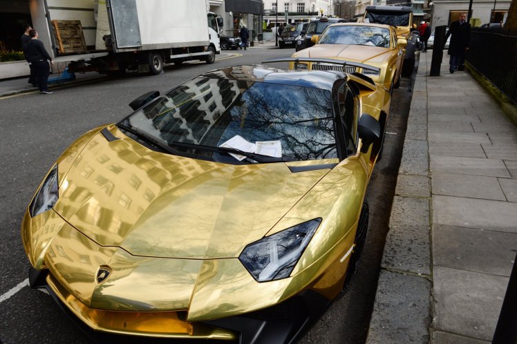 Three gold cars from Saudi Arabia (back-front) a 6x6 Mercedes G 63, Rolls-Royce Phantom Coupe and Lamborghini Aventador have received parking tickets on Cadogan Place in Knightsbridge, London. PRESS ASSOCIATION Photo. Picture date: Wednesday March 30, 2016. See PA story TRANSPORT Knightsbridge. Photo credit should read: Stefan Rousseau/PA Wire