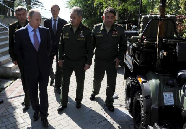 Russian President Vladimir Putin (2nd L) accompanied by Defence Minister Sergei Shoigu (2nd R), Russian Armed Forces Chief of Staff Valery Gerasimov (L) and Industry and Trade Minister Denis Manturov (C) inspects military vehicles after a meeting with military and defense industries' officials at the Bocharov Ruchei state residence in Sochi, Russia, May 12, 2016. Mikhail Klimentyev/Sputnik/Kremlin via Reuters
