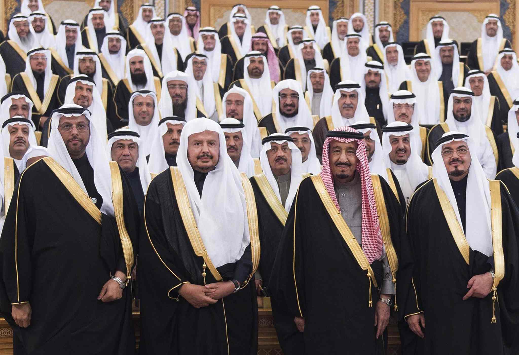 FILE - In this Tuesday, Jan. 6, 2015, file mage released by Saudi Press Agency, SPA, Saudi Arabia's Crown Prince Salman bin Abdulaziz Al Saud, 2nd right first row, poses with Shura members at consultative Shura Council in Riyadh, Saudi Arabia. Saudi Arabia's new monarch isn't wasting time. Since assuming the throne Jan. 23, King Salman has elevated some of his closest relatives and sidelined previous power-brokers, tightened decision-making and promised lavish payouts designed to win early goodwill. (AP Photo/Saudi Press Agency, File)